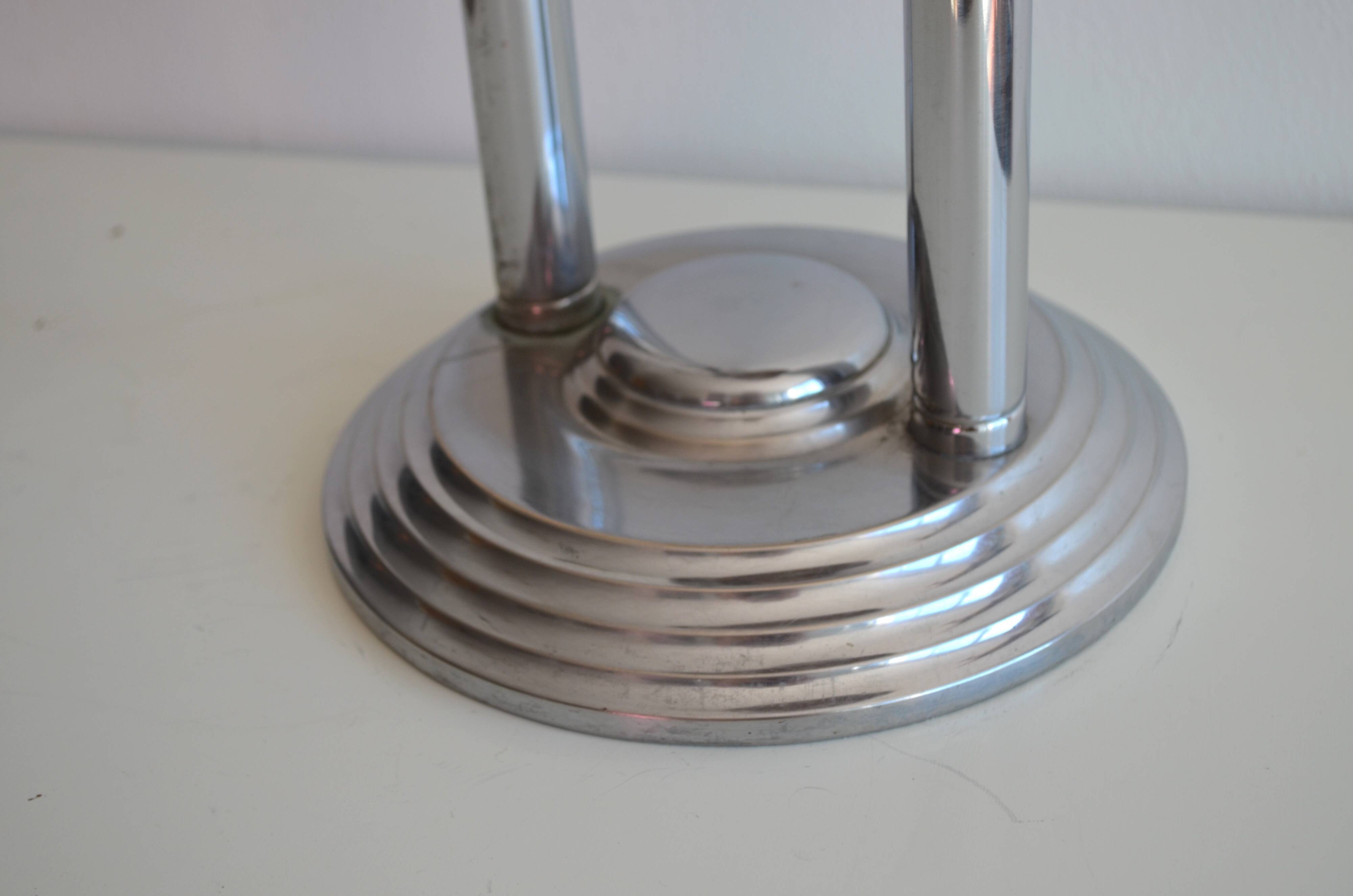 Ashtray and shelf on chrome metal stand.