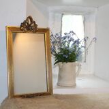 Small rectangular mirror in gilded wood with a pediment decorated with flowers
