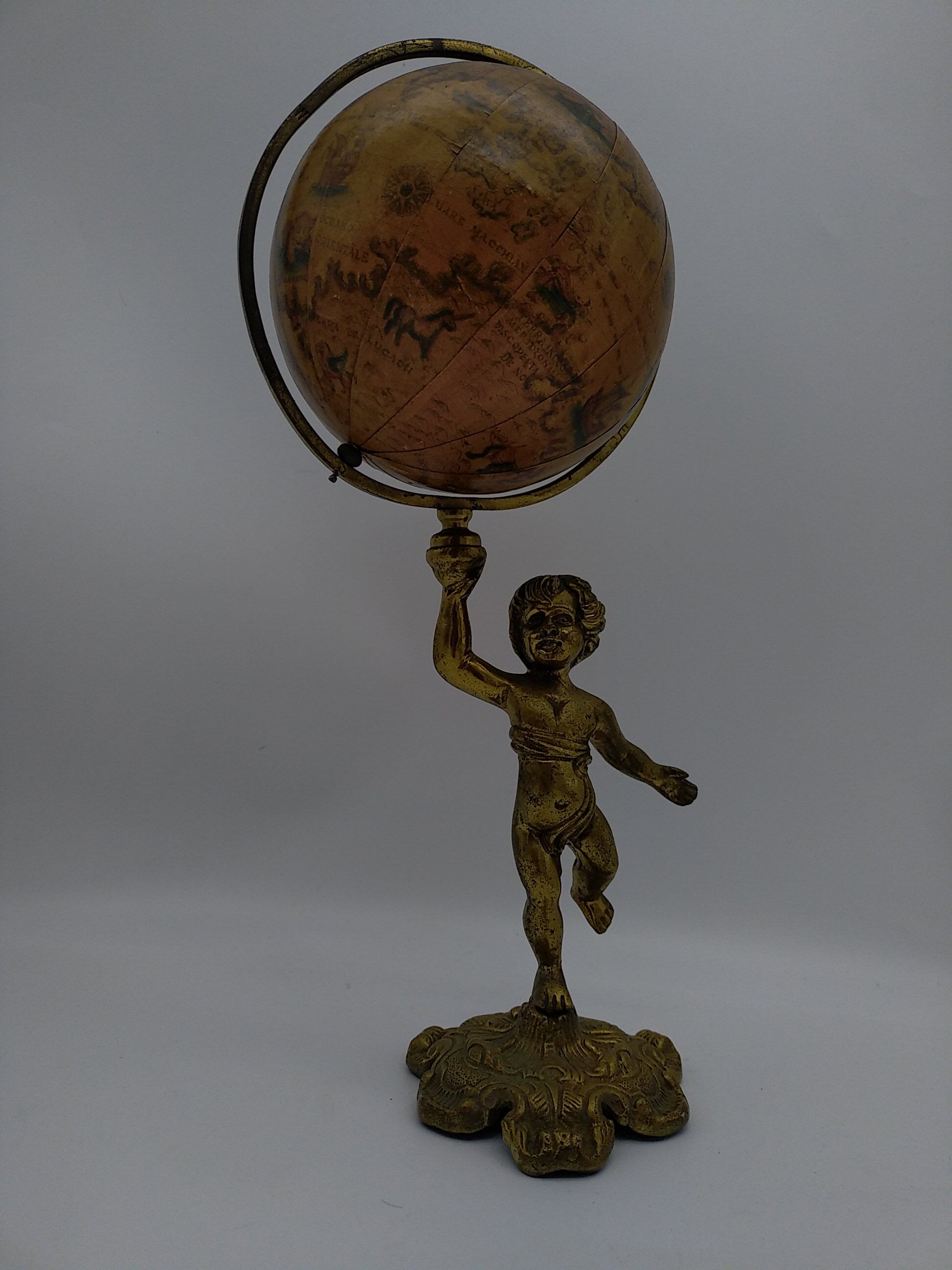 Cherub or putti carrying a globe