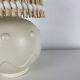 Vintage ceramic lamp with wicker and cotton shade.