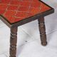 Brutalist coffee table in orange ceramic and solid wood.