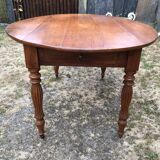 Louis Philippe oval shuttered table in solid cherry wood with 2 drawers.