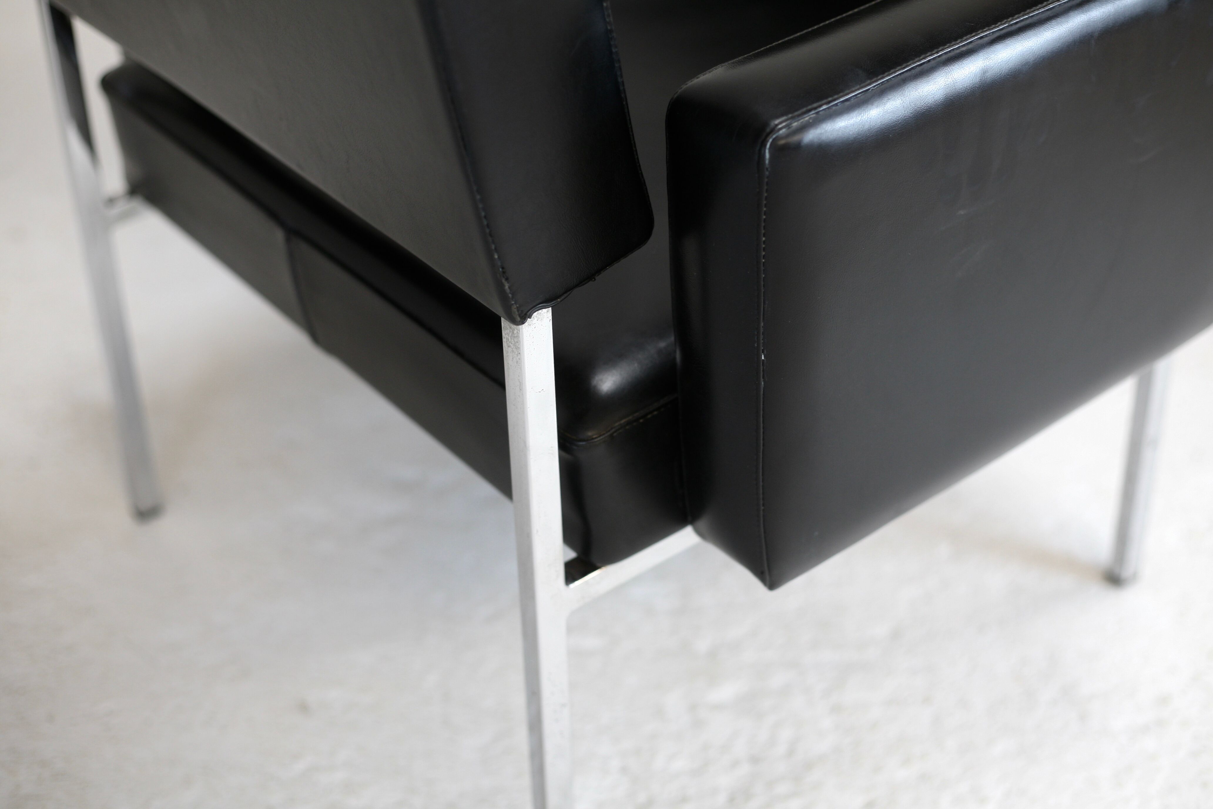 Pair of stainless steel, black leather-like armchairs, France, circa 1970