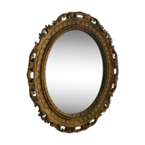 Old oval mirror in gilded resin
