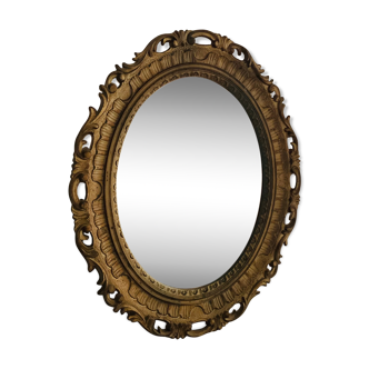 Old oval mirror in gilded resin