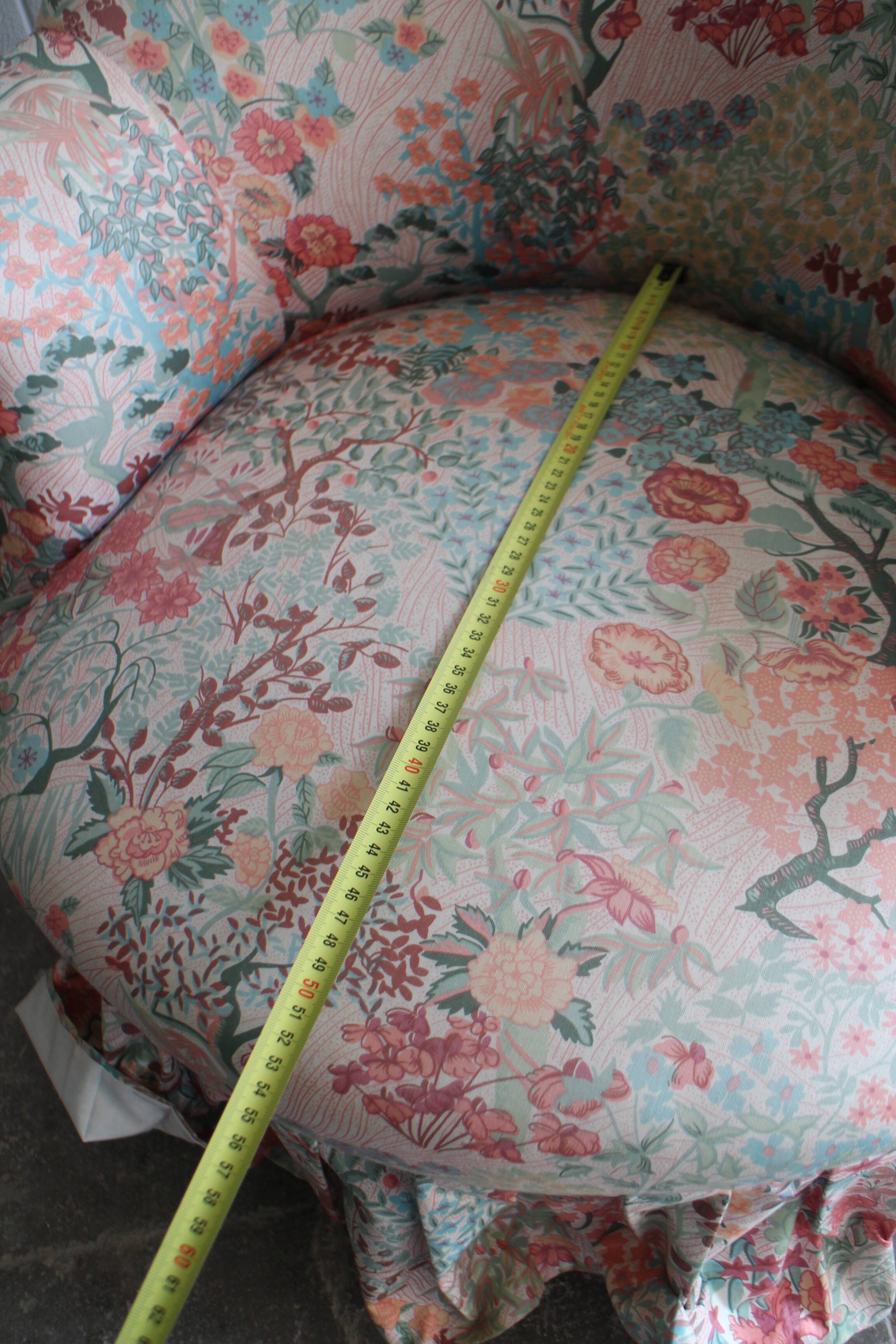 pair of toad armchairs in floral fabric.