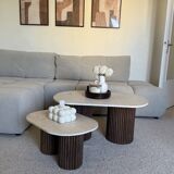 Oval coffee table duo travertine and fluted wooden legs.