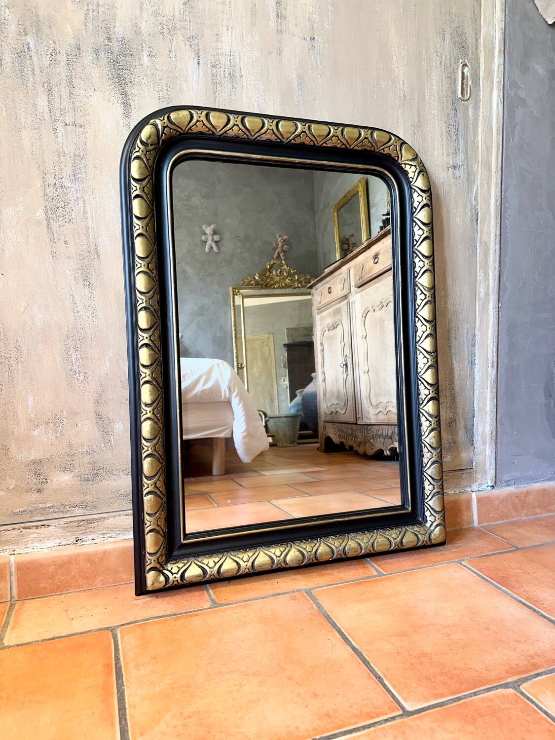 Louis-Philippe black and gold antique mirror from the 19th century