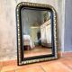 Louis-Philippe black and gold antique mirror from the 19th century