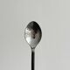 Two small hammered metal teaspoons with a snail pattern.