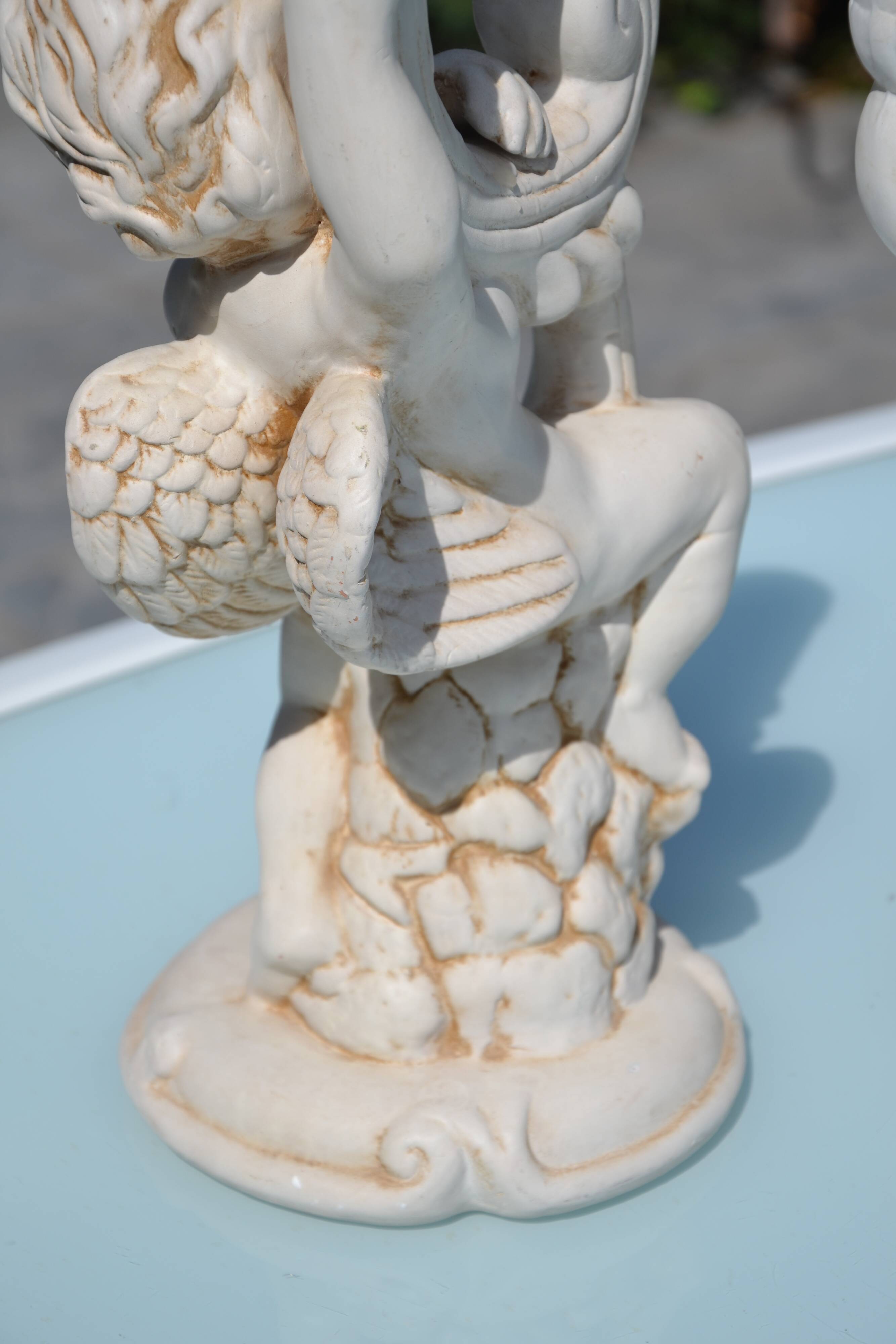 Pair of "cherub" candle holders in plaster