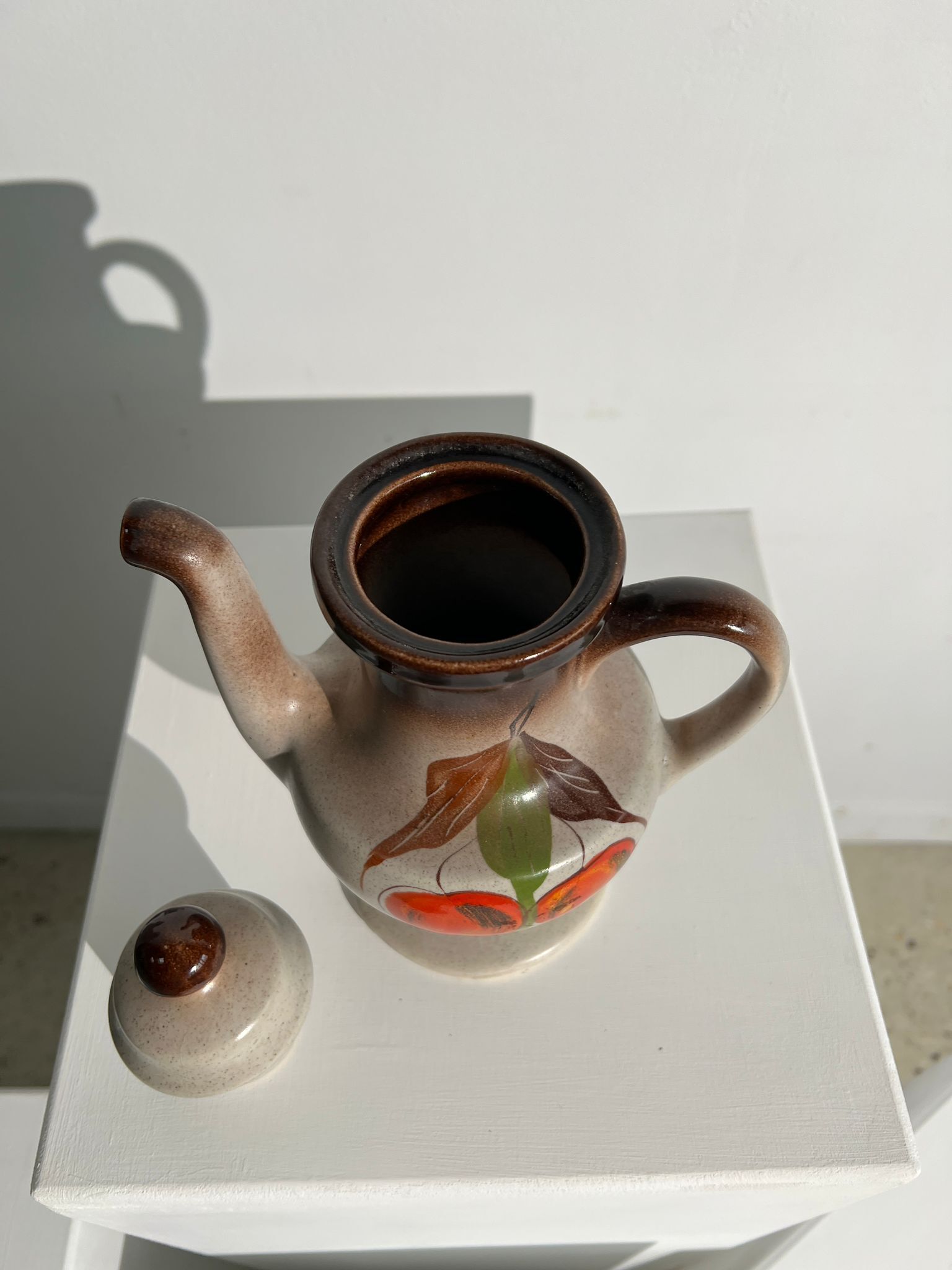 Vintage stoneware teapot with flower and fruit patterns