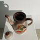 Vintage stoneware teapot with flower and fruit patterns