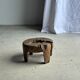 Small low circular four-legged stool in organic old teak with cut-out design H2