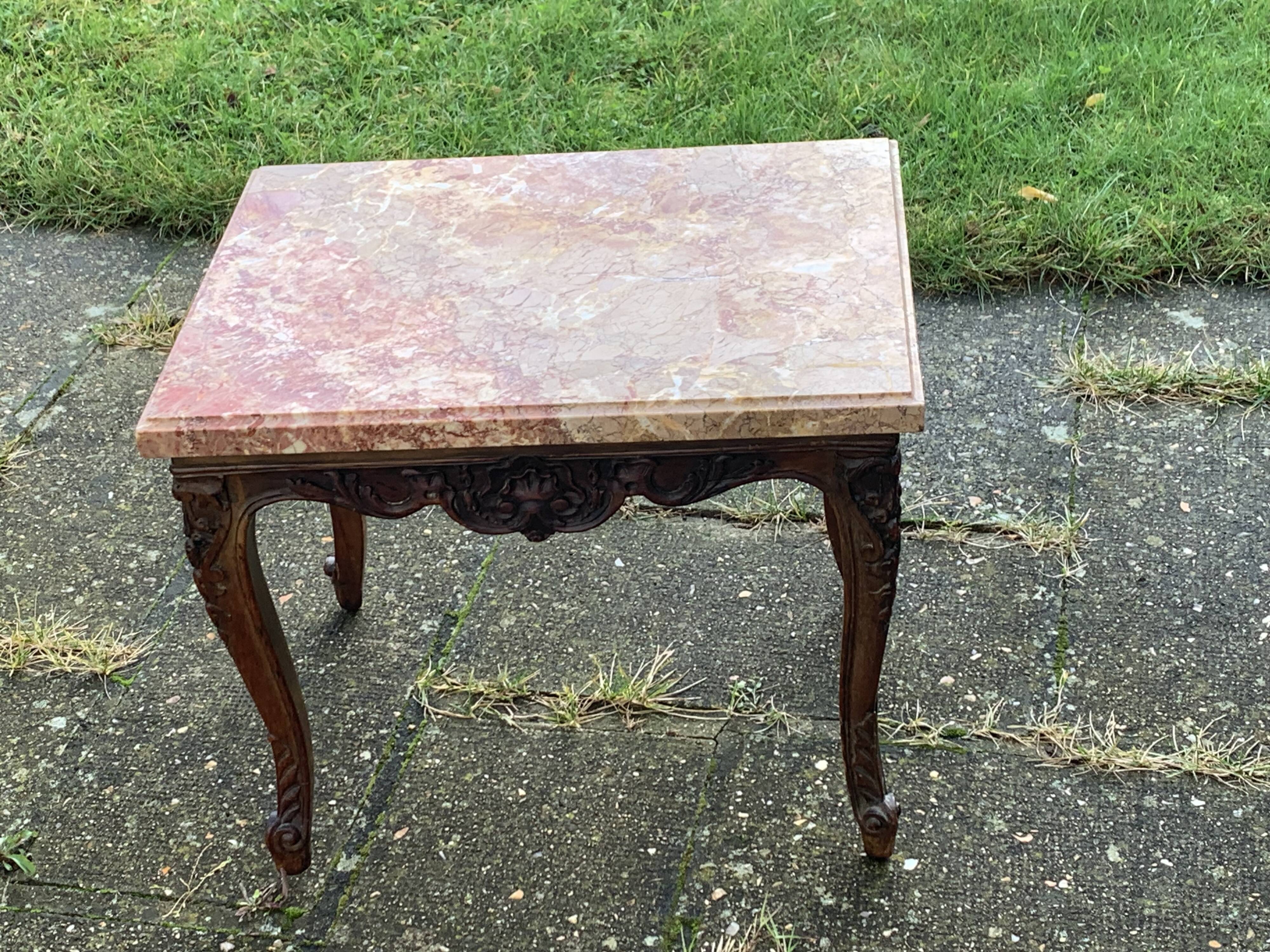 Carved wooden coffee table with shell pattern and removable pink marble top, old