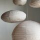 Average suspension in natural rattan and linen, Japanese-style, flattened oval in pink.
