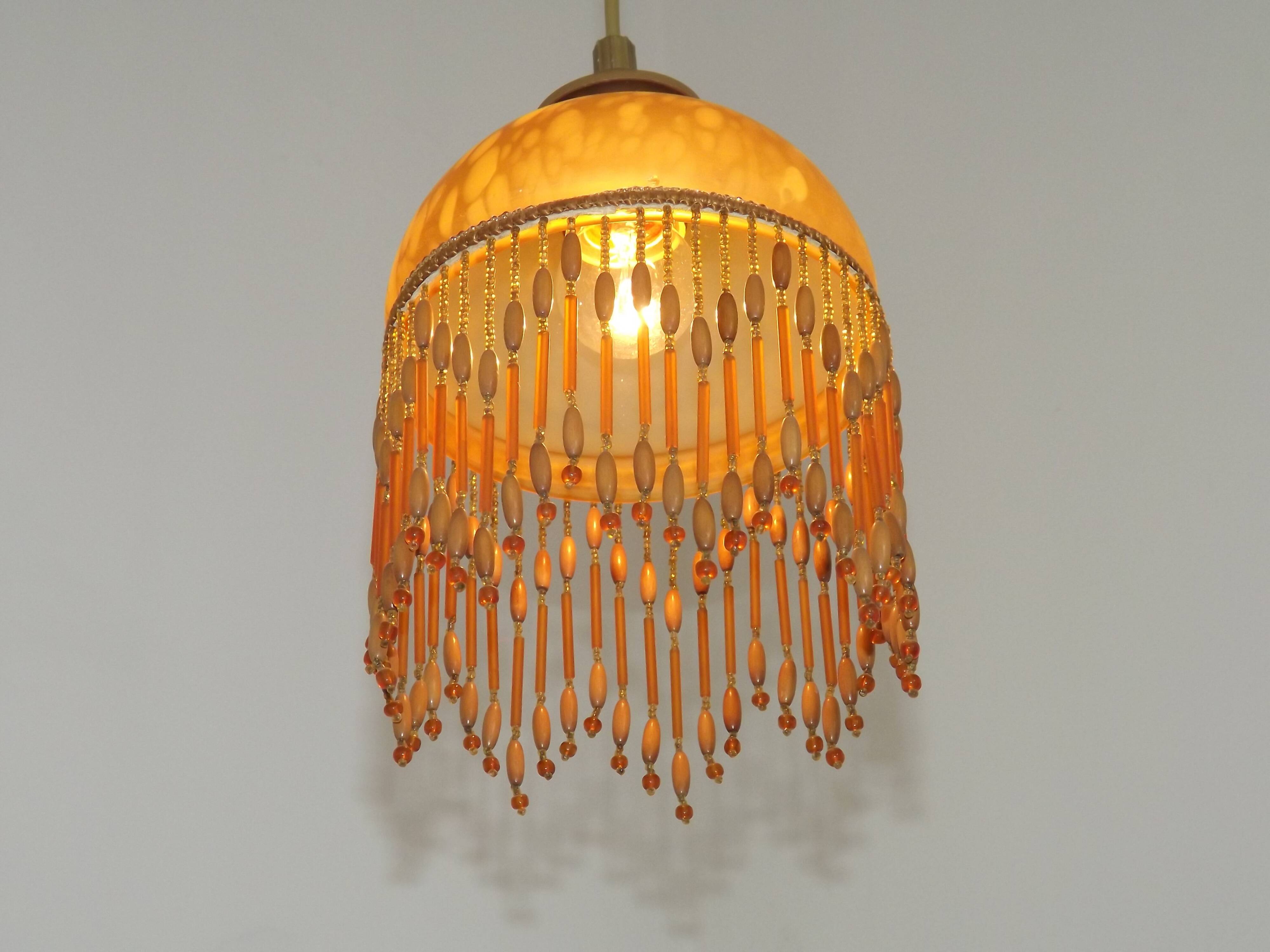 Vintage French amber mottled glass hanging ceiling light with beaded fringe.