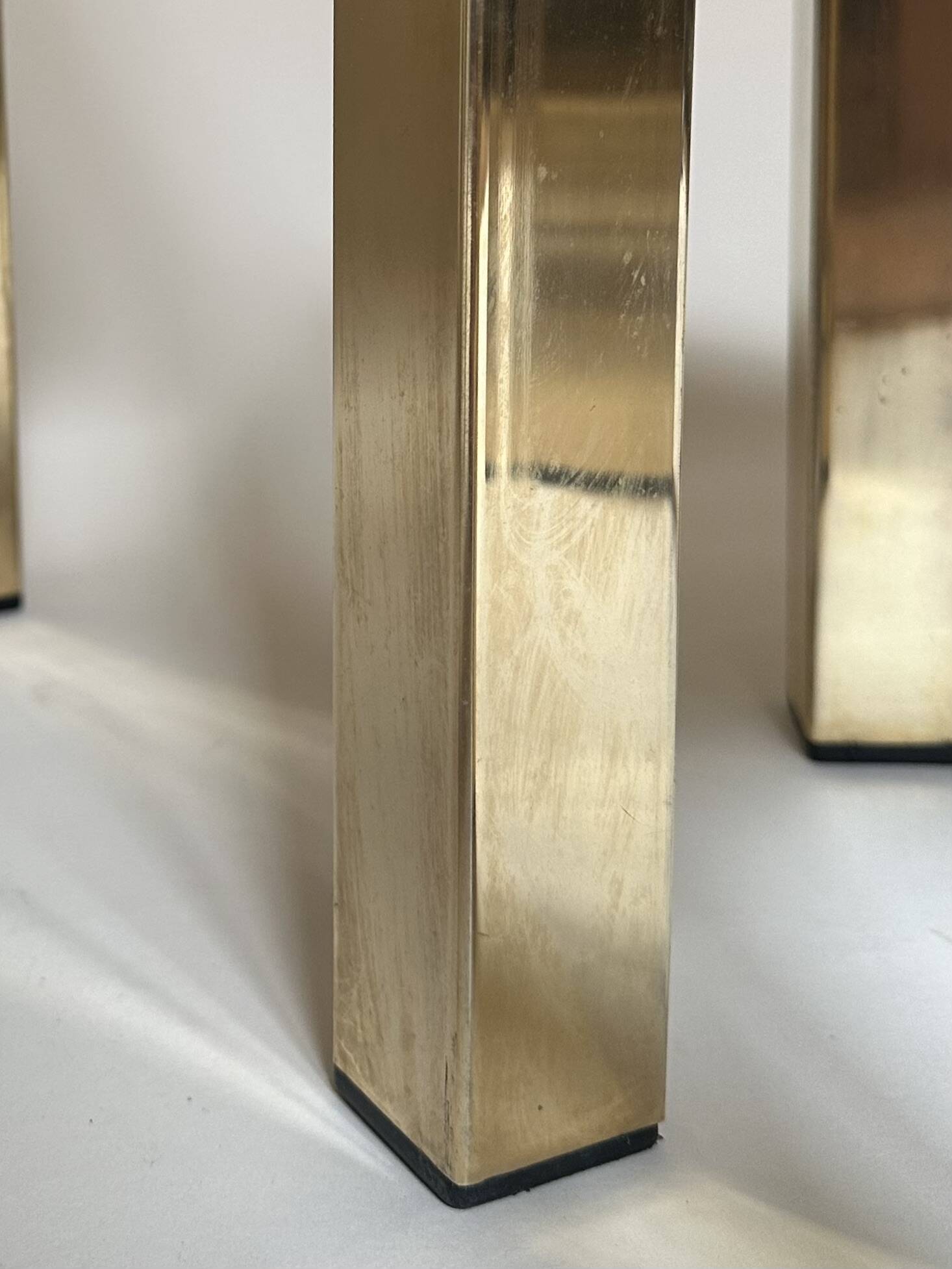 Set of three nesting side tables in brass and smoked mirror.