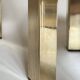 Set of three nesting side tables in brass and smoked mirror.