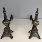 Pair of chiselled bronze and wrought iron fire dogs in the Louis XVI style.