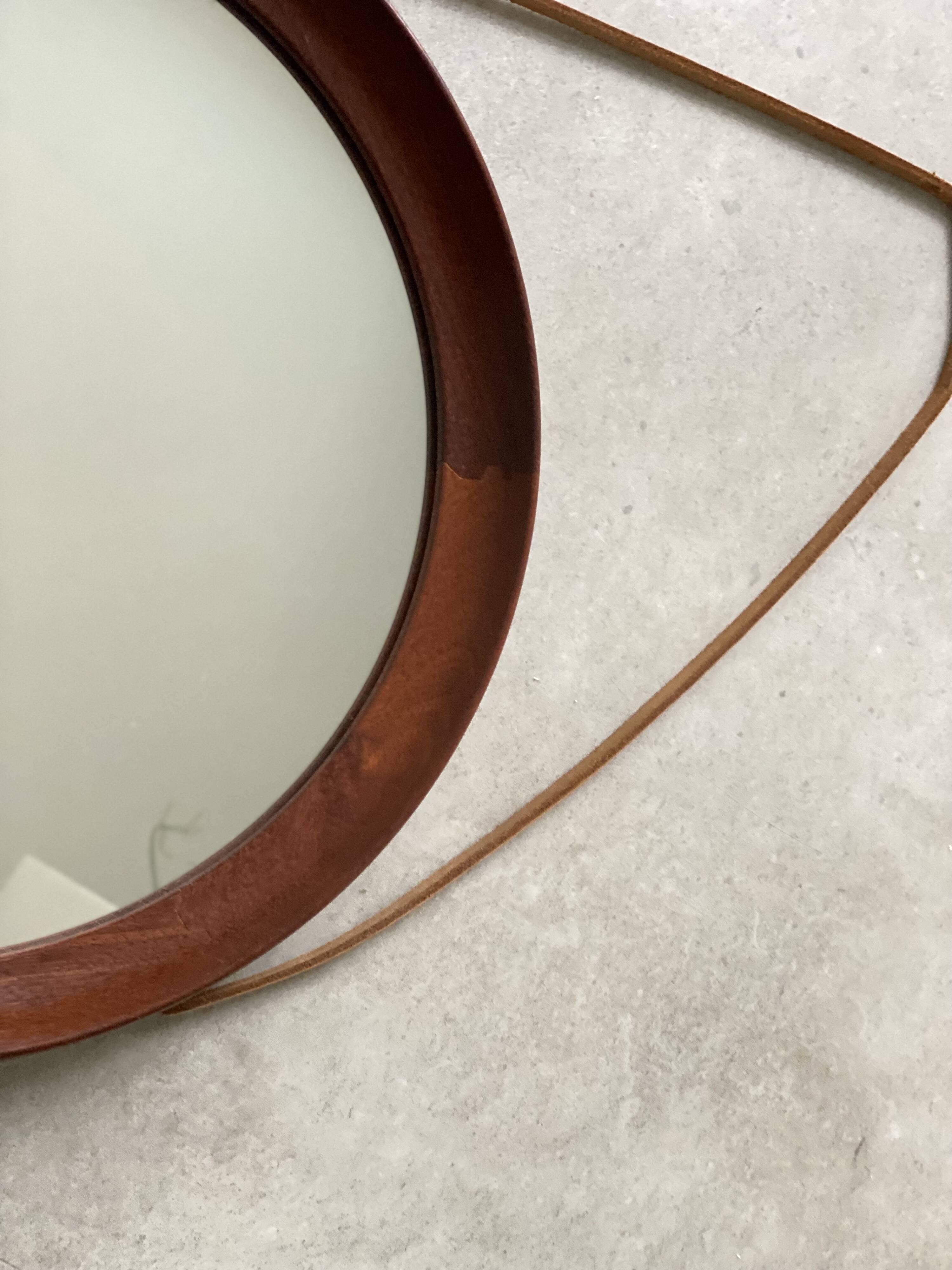 Mid Century solid teak wall mirror with a leather strap - Danish design