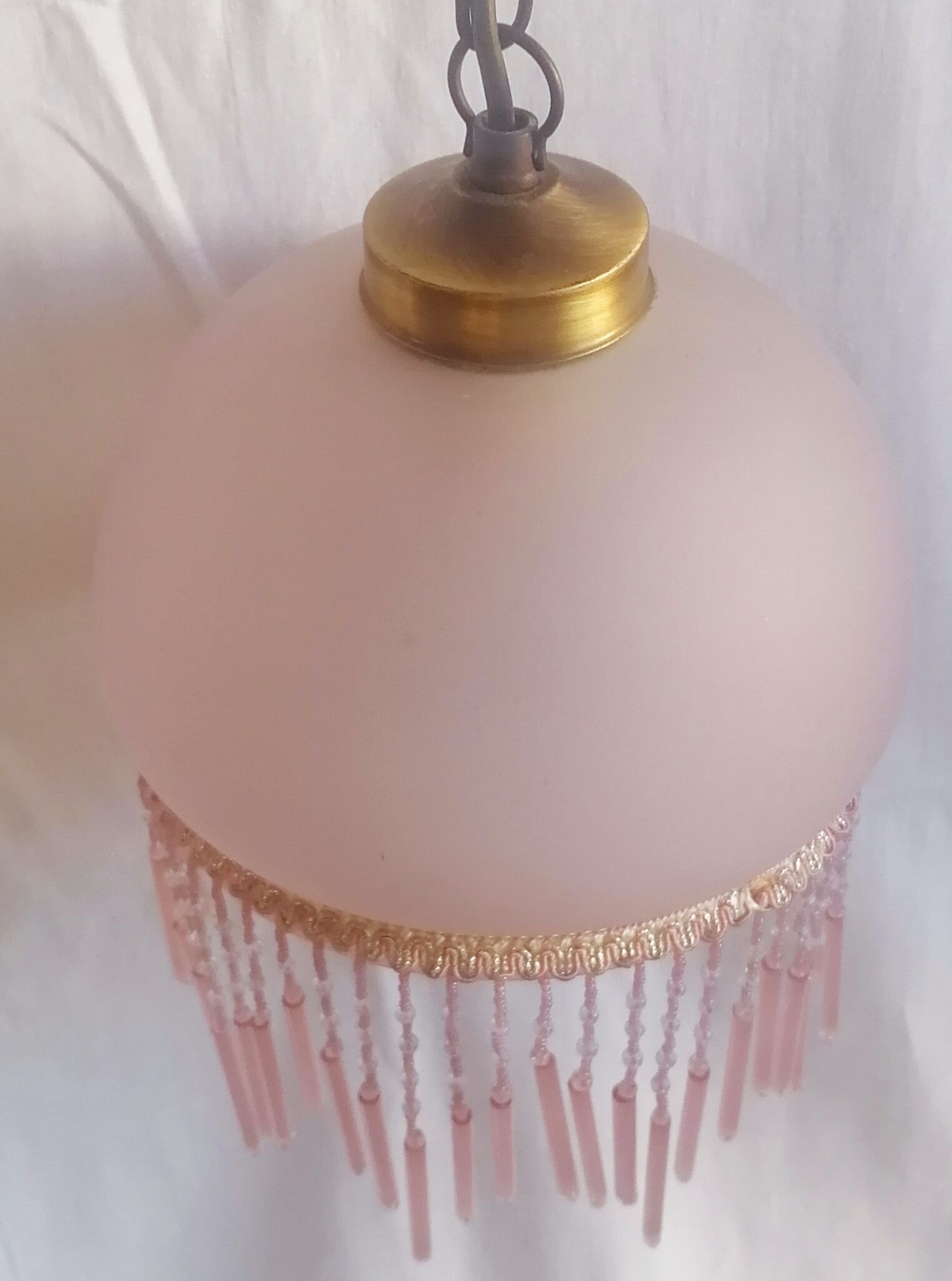 Hanging bell and pink glass garland