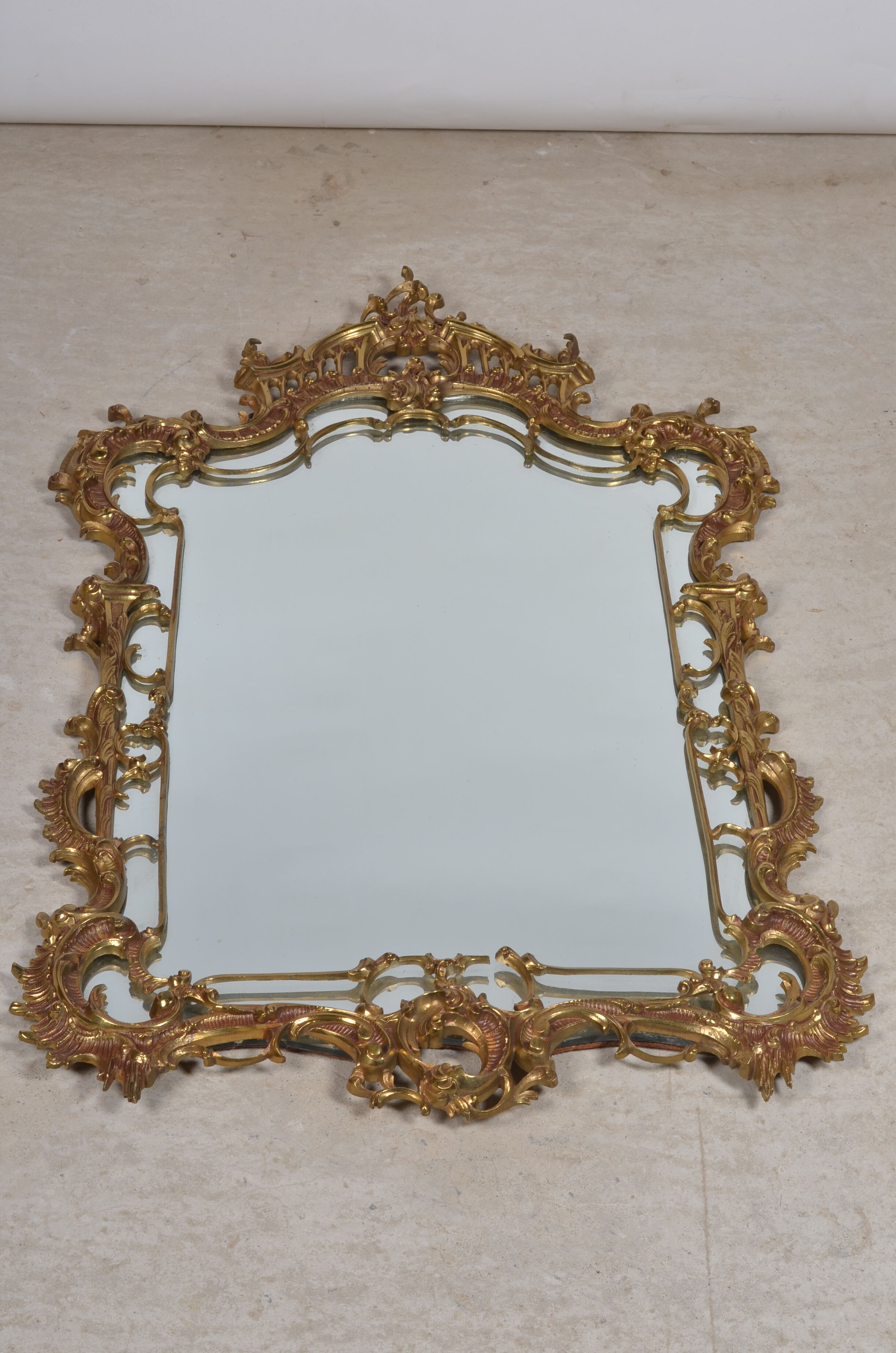 Mirror with baroque style parecloses in bronze 102 x 61 cm