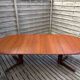 Oval teak table extendable with two leaves, Baumann style.