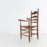 Antique wooden armchair with cane seat, France ca. 1900