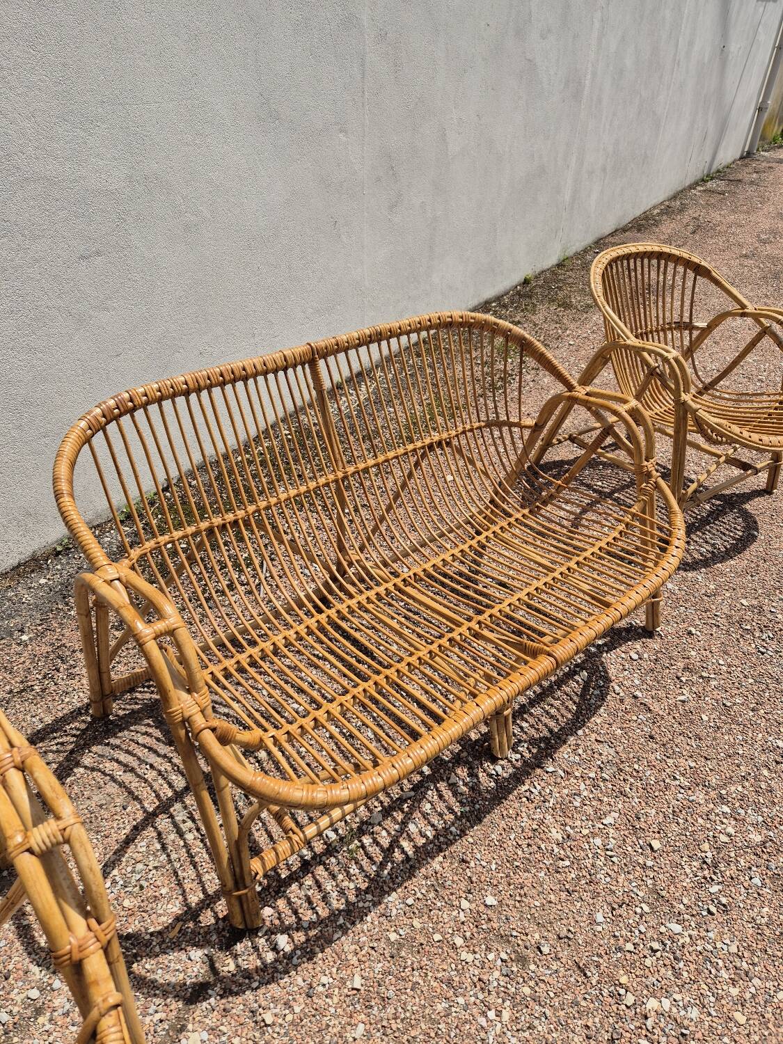 Rattan lounge with two armchairs and a vintage 1950s bench.