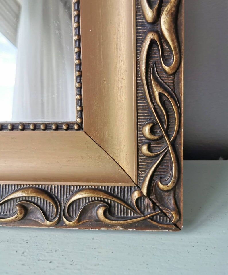 Beautiful French vintage mirror in gilded wood from the 60s