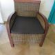 2 colonial-style armchairs in woven rattan and exotic wood