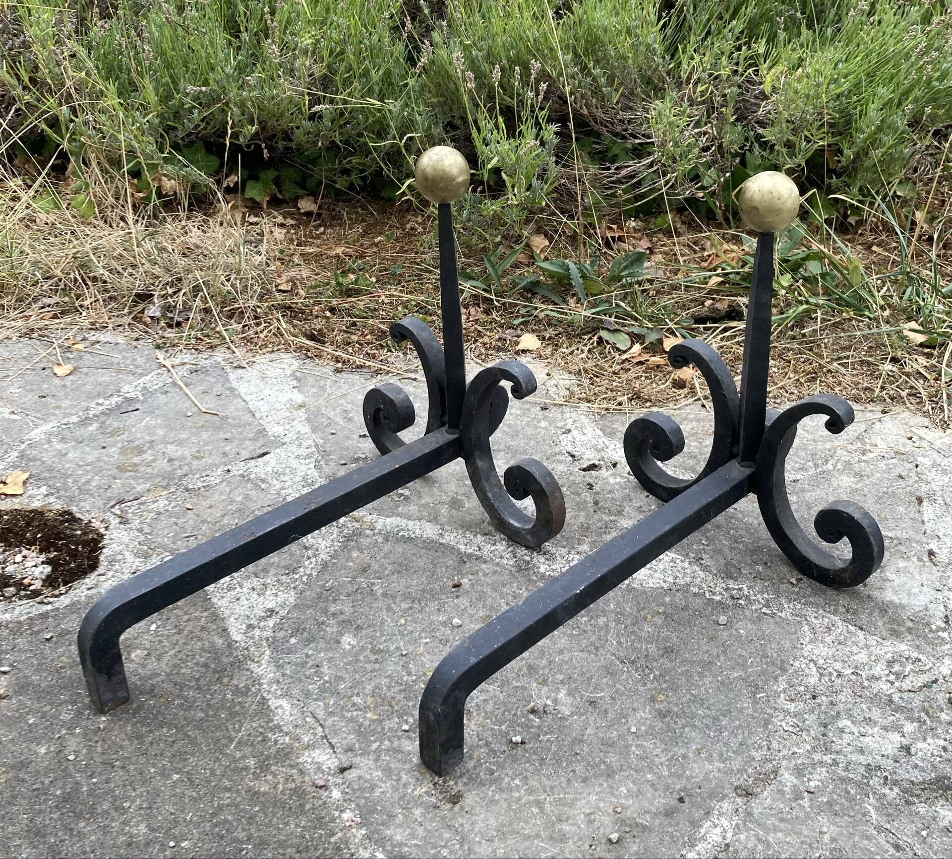 Massive wrought iron chenets from the 19th century topped with brass balls.