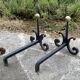 Massive wrought iron chenets from the 19th century topped with brass balls.