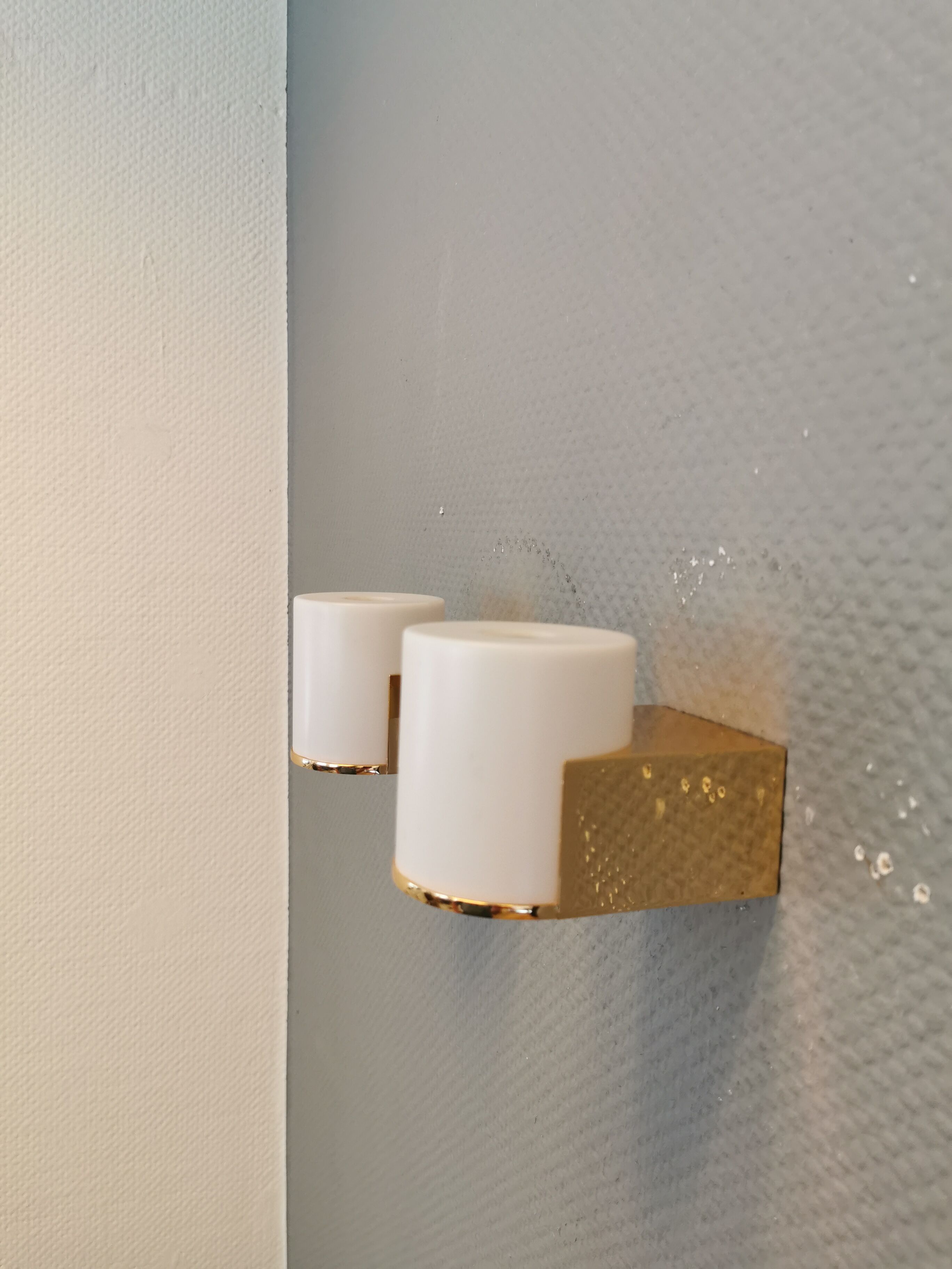 Wall lamps with milky white acrylic plastic shades and solid brass bases