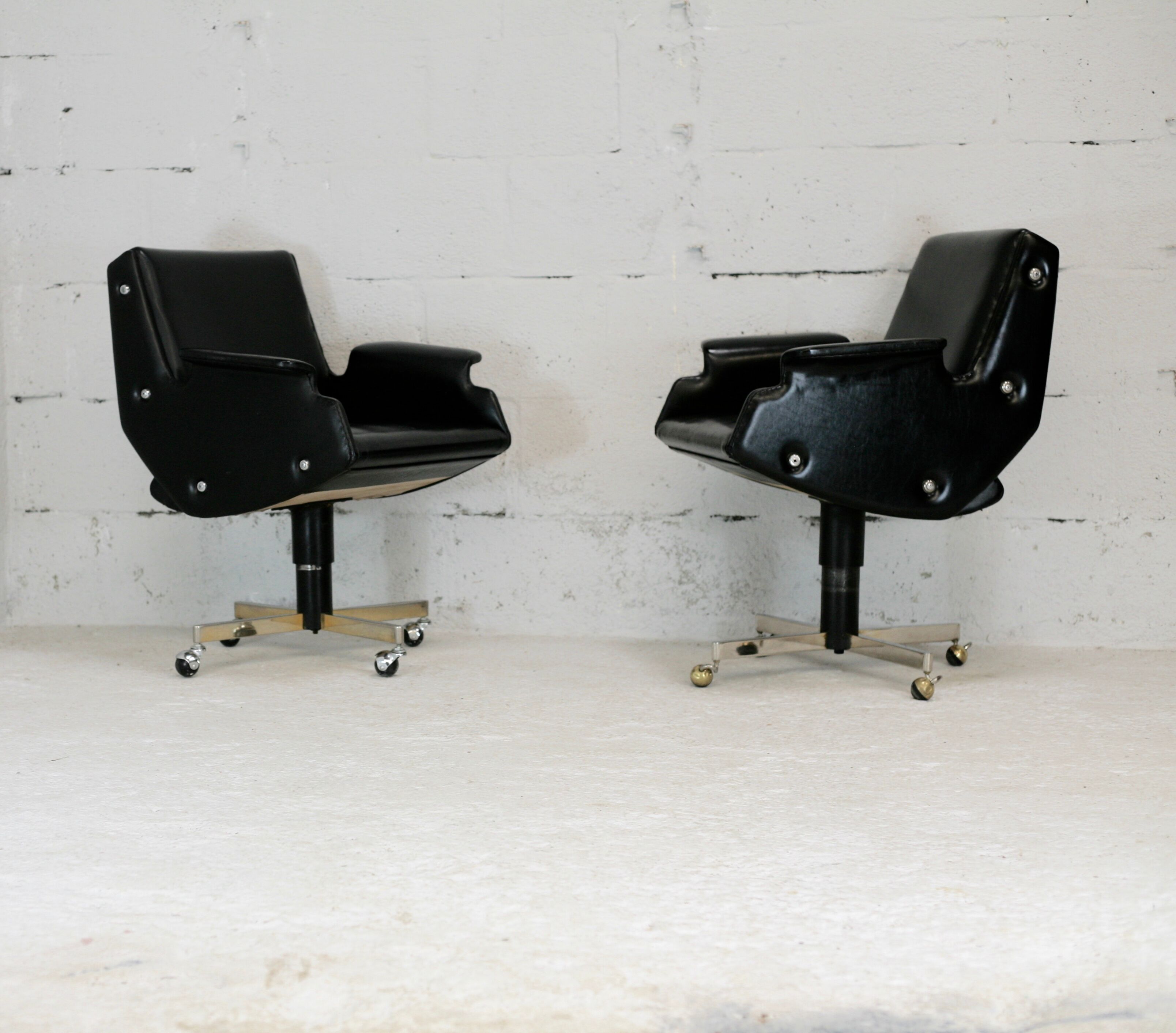 Pair of swivel armchairs, imitation leather and steel, Italy, circa 1960.