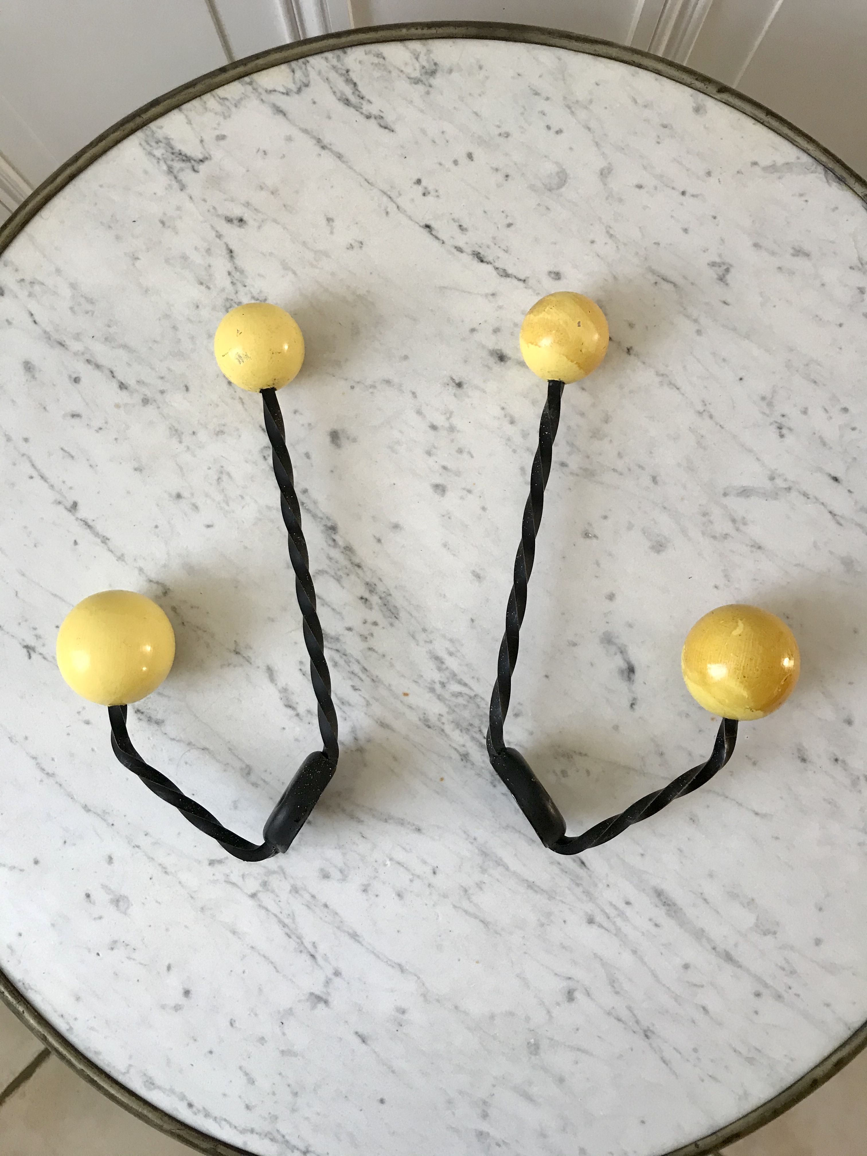 Duo of hooks balls in yellow wood and black iron 60s