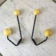 Duo of hooks balls in yellow wood and black iron 60s
