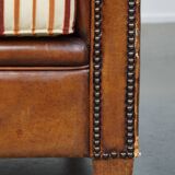 Set of 2 cognac-colored sheepskin club chairs with colorful fabric cushions