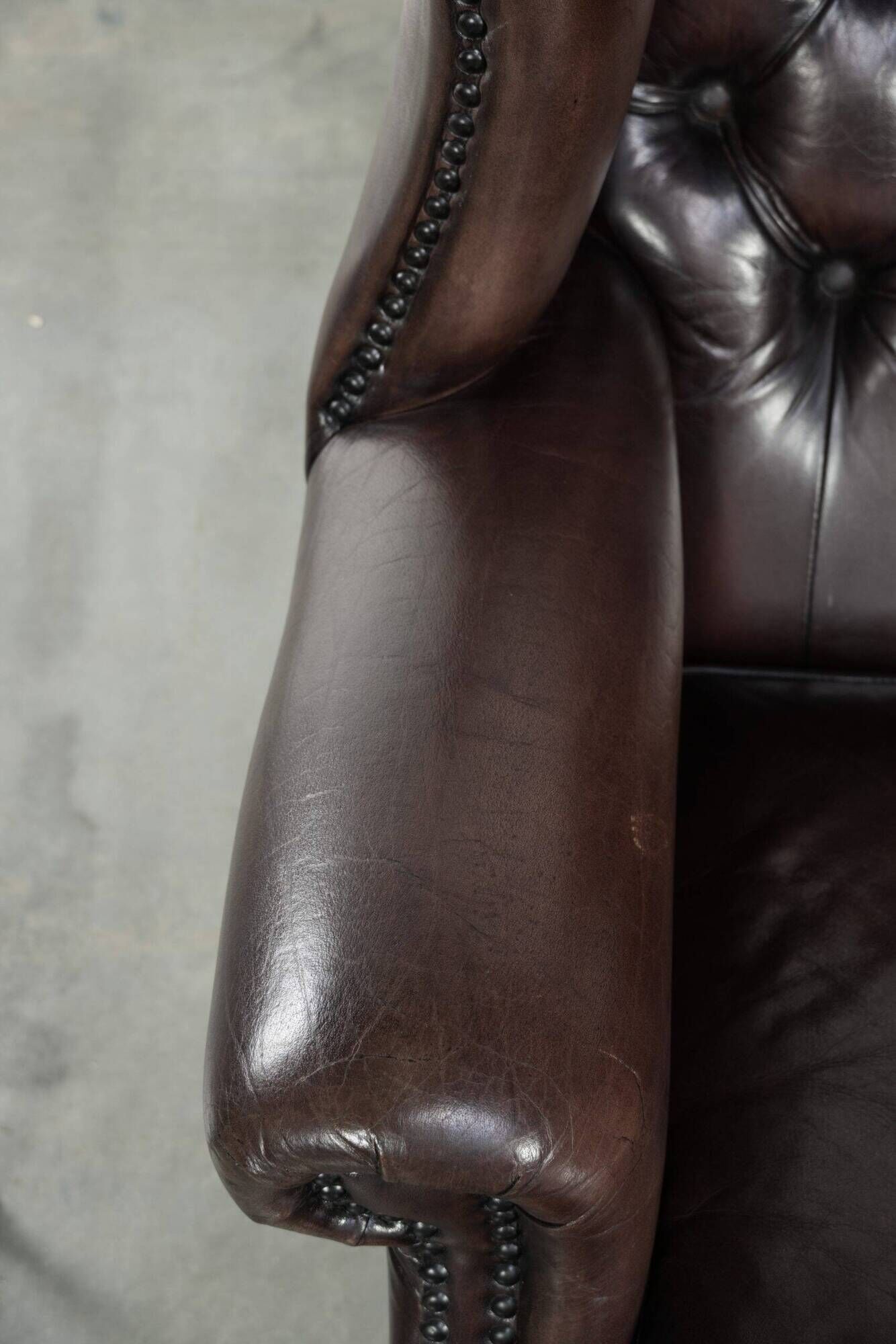 Dark brown cowhide Chesterfield wingback armchair in classic English style