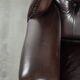 Dark brown cowhide Chesterfield wingback armchair in classic English style