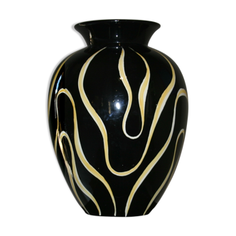 Black ceramic vase and yellow flames