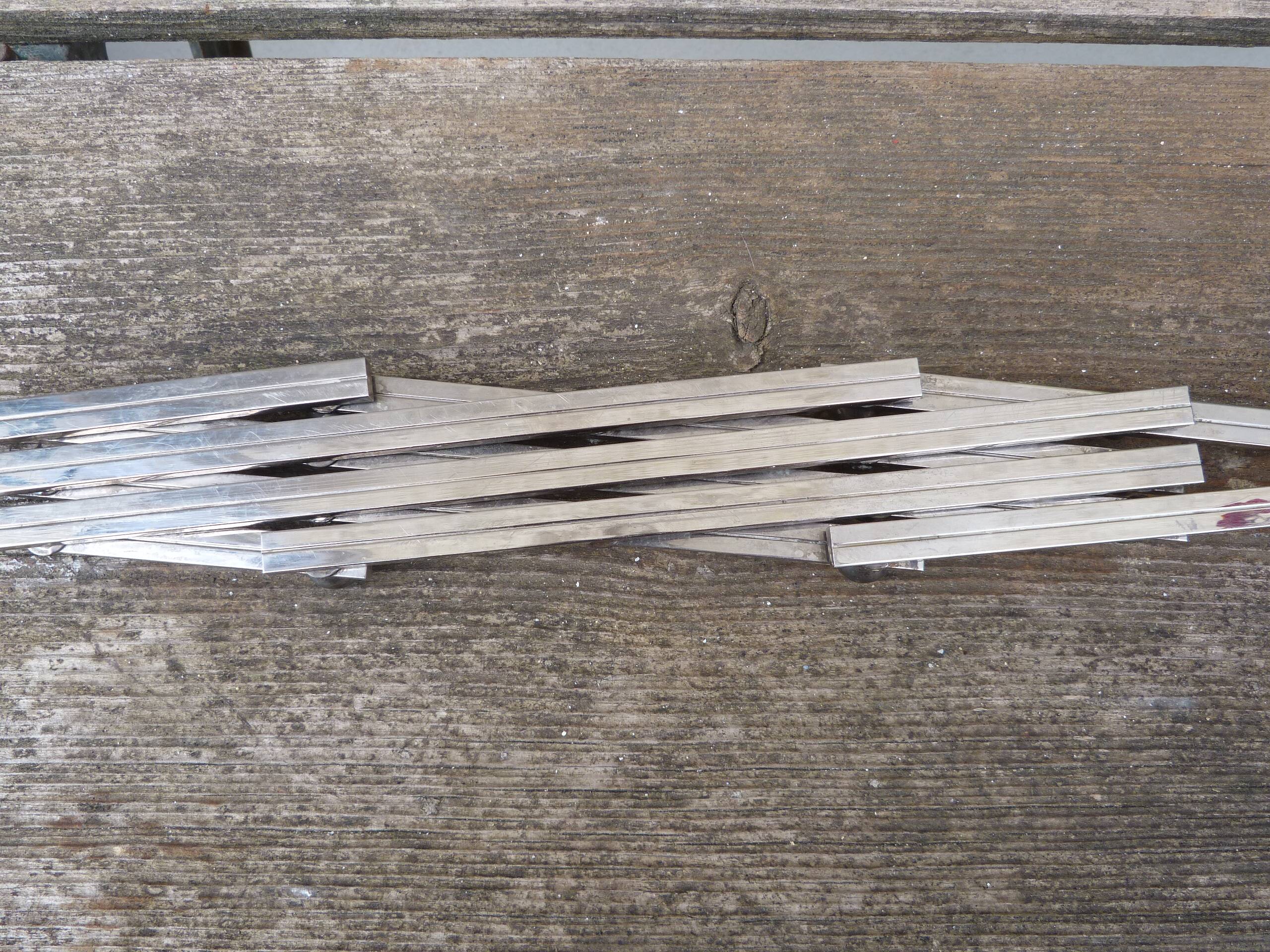 Modernist design foldable trivet in silver metal Jacques Adnet 1940/1950