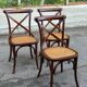 4 bistro chairs with curved wooden backs and cross braces / Crossback