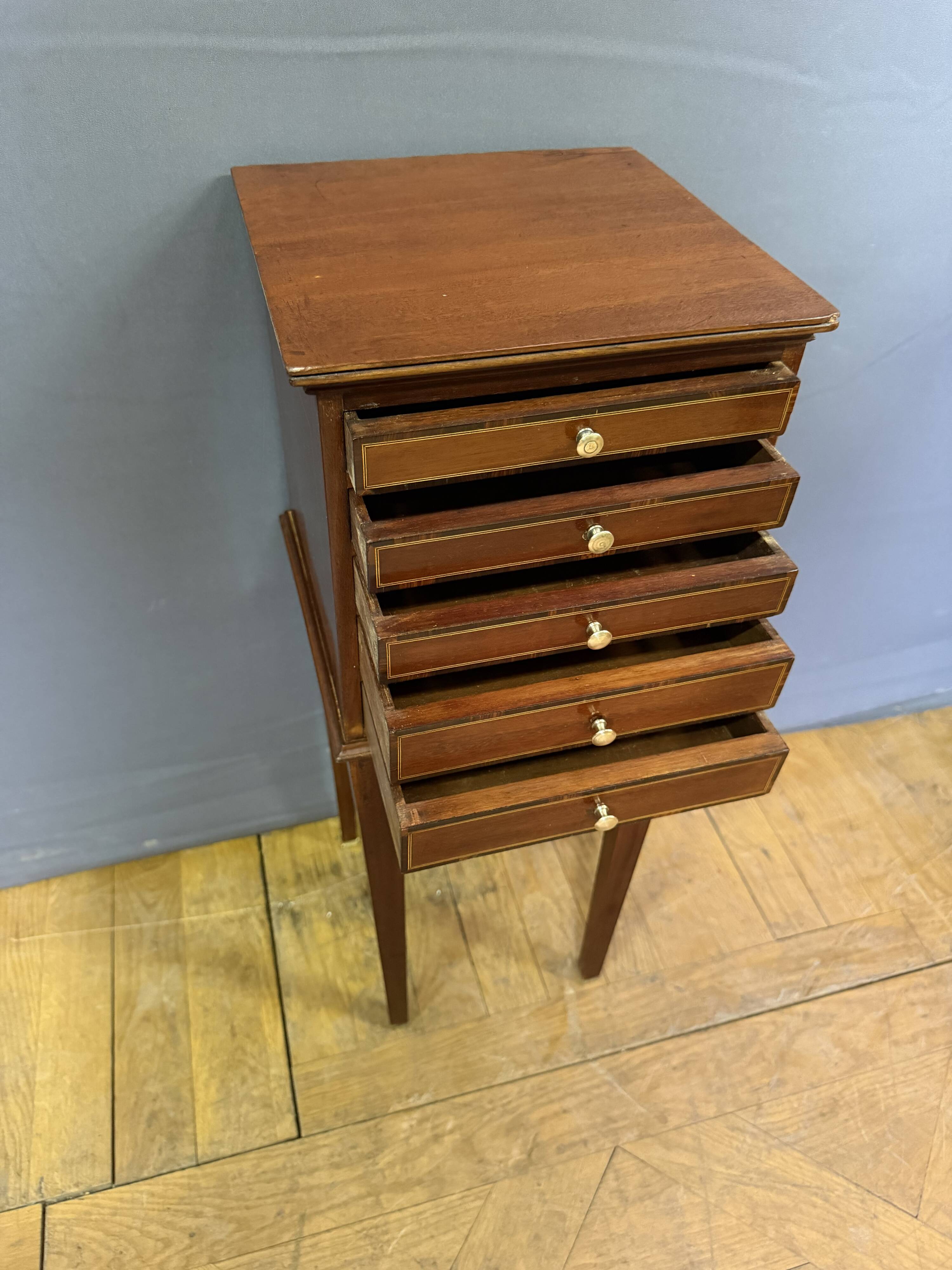 Louis XVI bedside table in mahogany with five drawers.