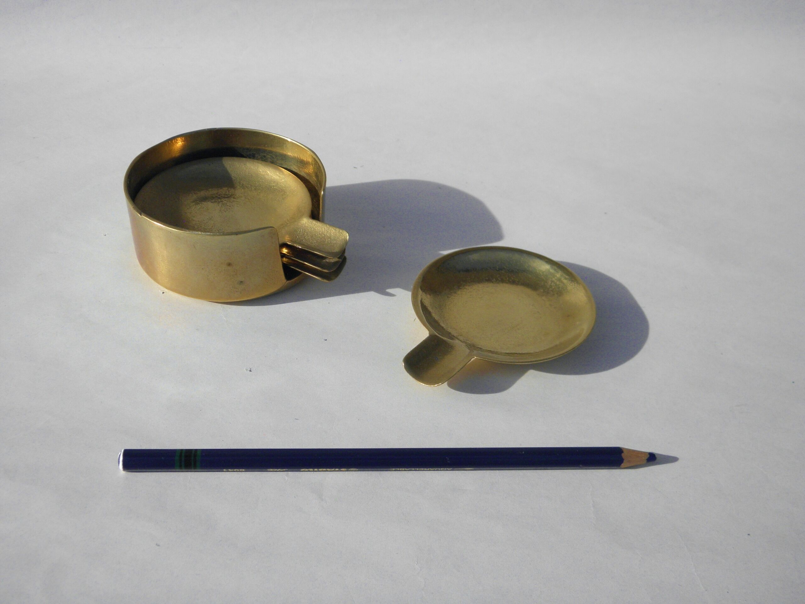 4 brass ashtrays in their 1970 case