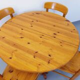 Suite of a round table with extension and 4 vintage pine chairs from the 60s and 70s