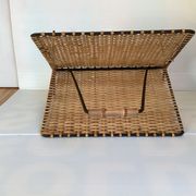 Old magazine rack in straw and black metal