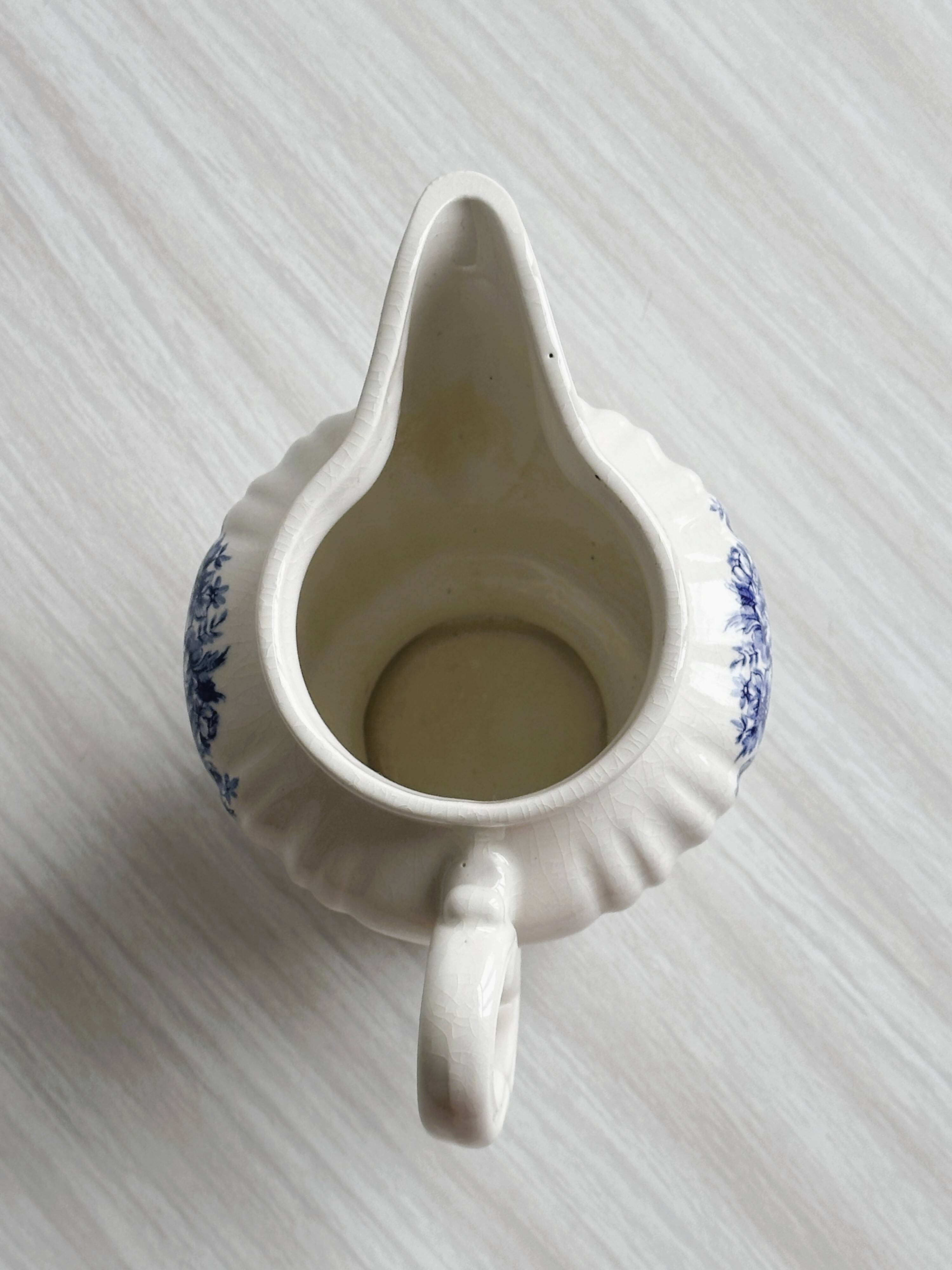 Porcelain sauce boat with blue pastoral pattern
