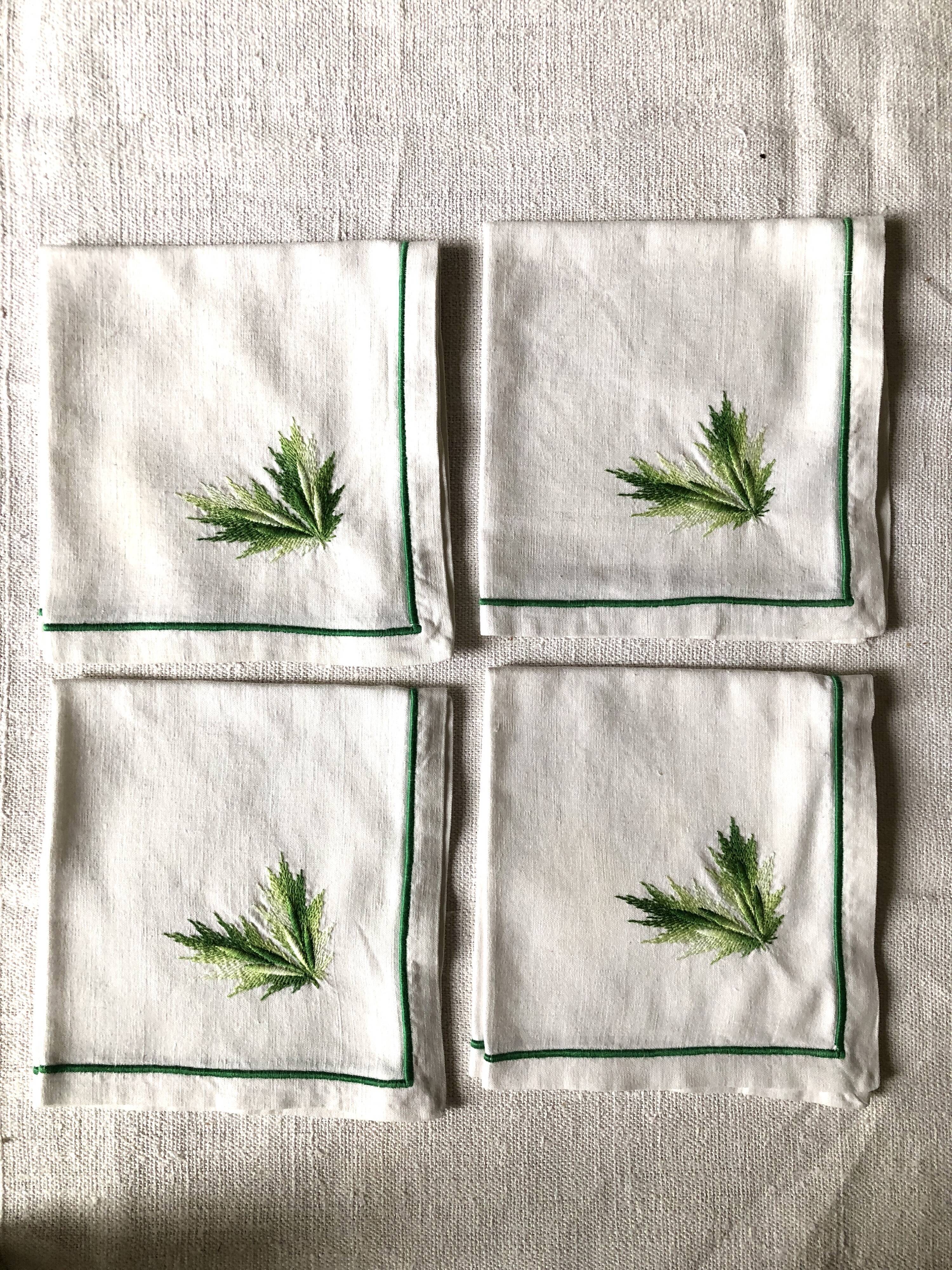 Series of four embroidered linen napkins